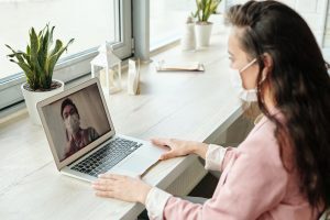 How Medical Practices Can Adapt During the COVID-19 Outbreak 1 Woman video chatting with doctor